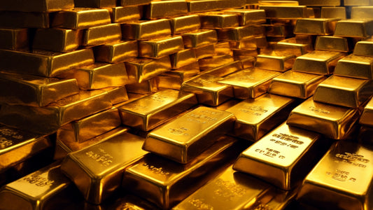 A close-up view of stacked gold bars, showcasing their lustrous and shiny surfaces. The bars are neatly arranged, highlighting their uniform size and weight, with visible markings indicating purity and weight.