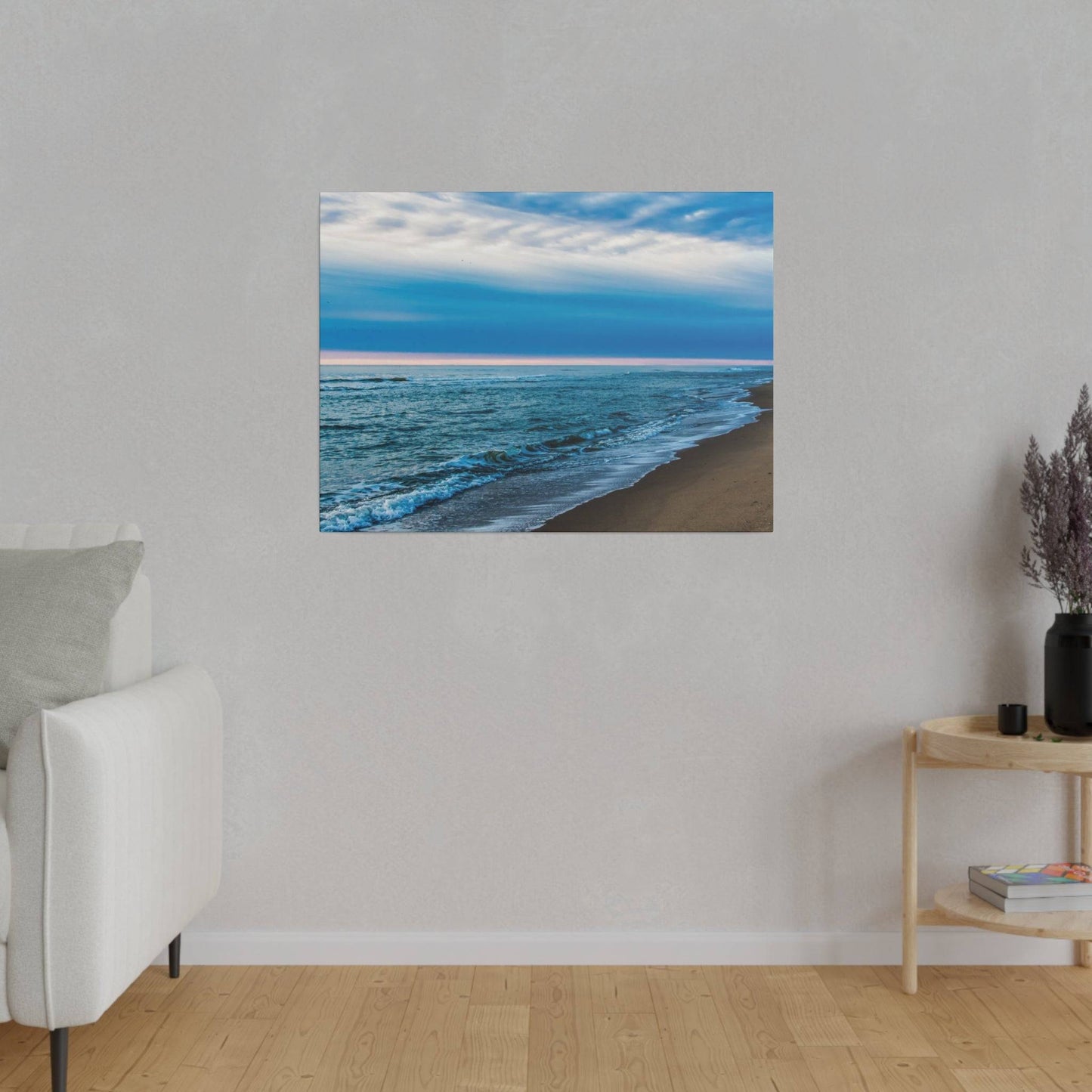 a living room with a couch and a painting on the wall
