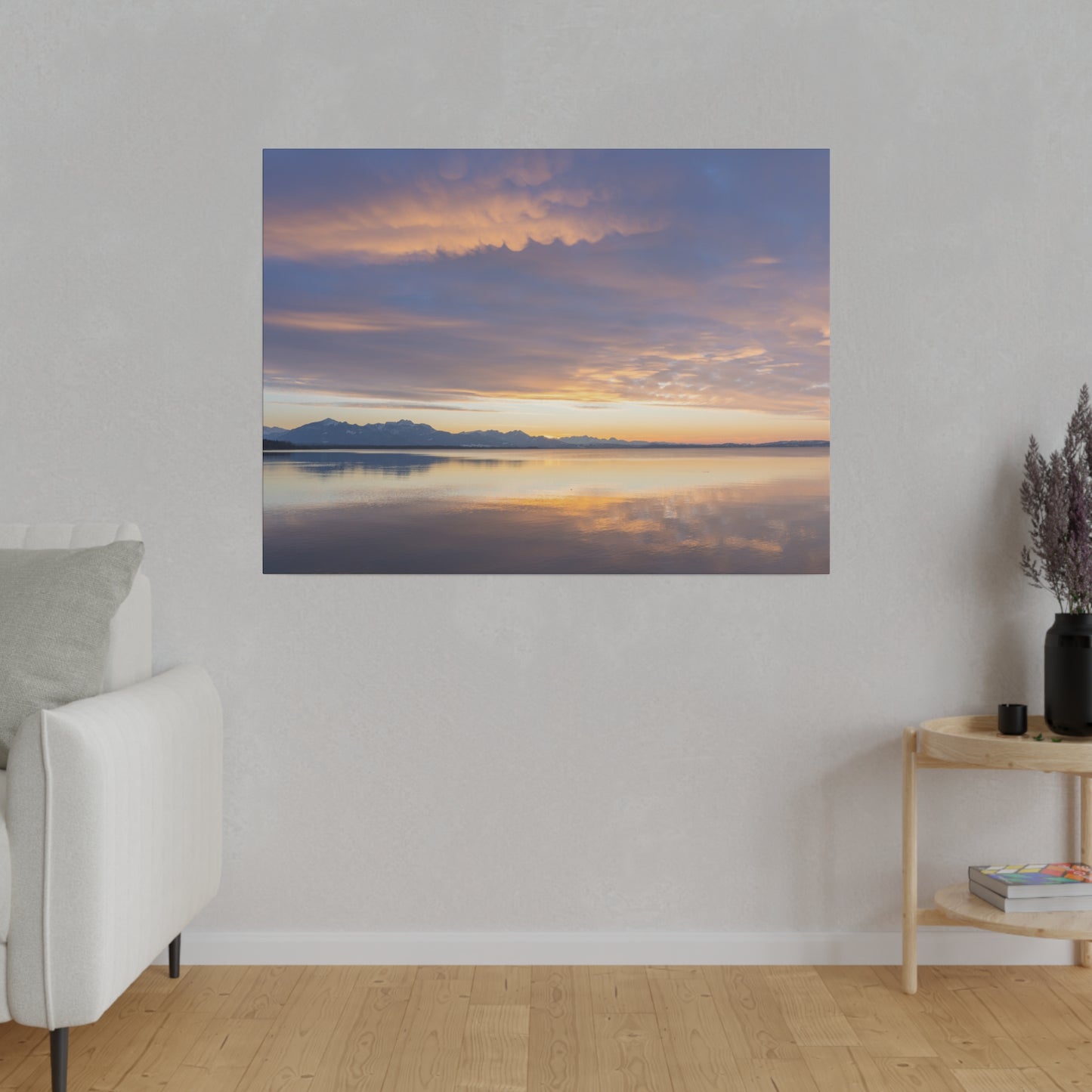 Dusk over a still water lake, with the sky painted in gentle hues of orange and purple. The tranquil water reflects the serene sunset scene, creating a peaceful atmosphere.