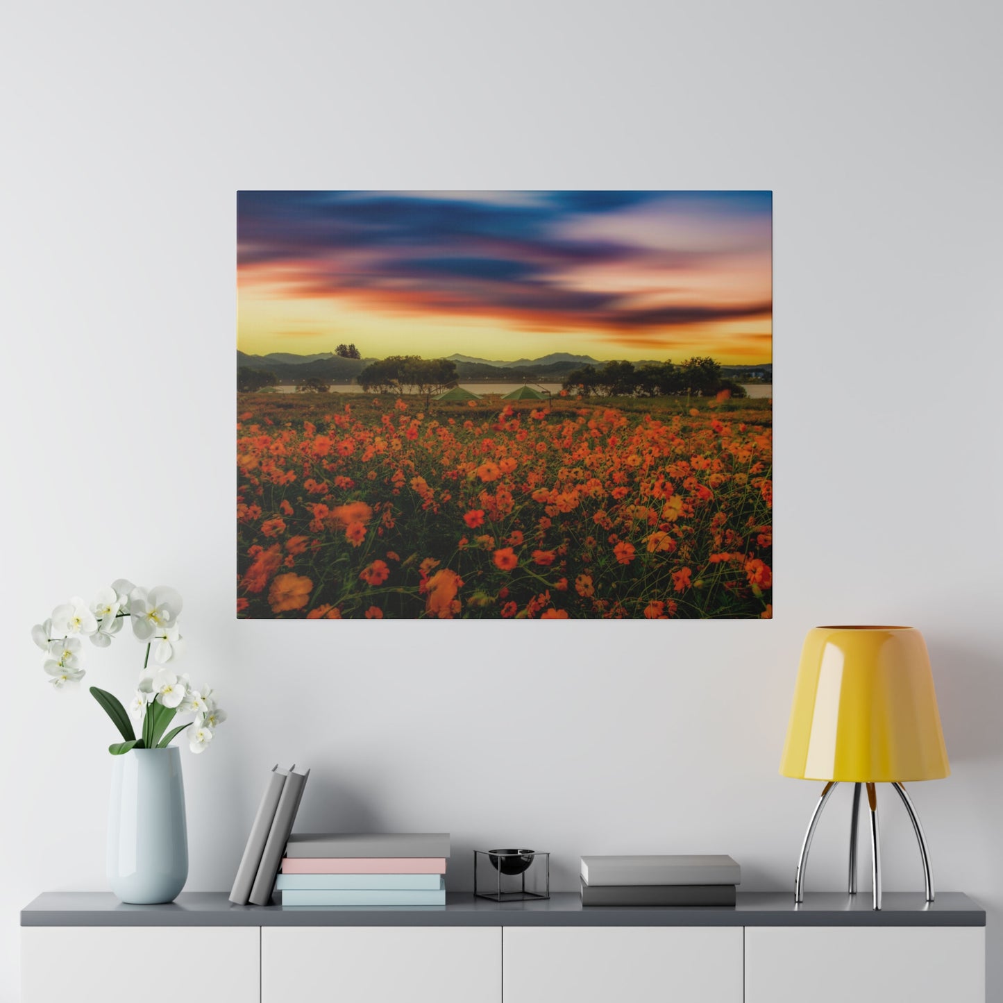 Dusk falls over a beautiful field of flowers, with the last light of the day illuminating the petals and casting a serene glow over the landscape.