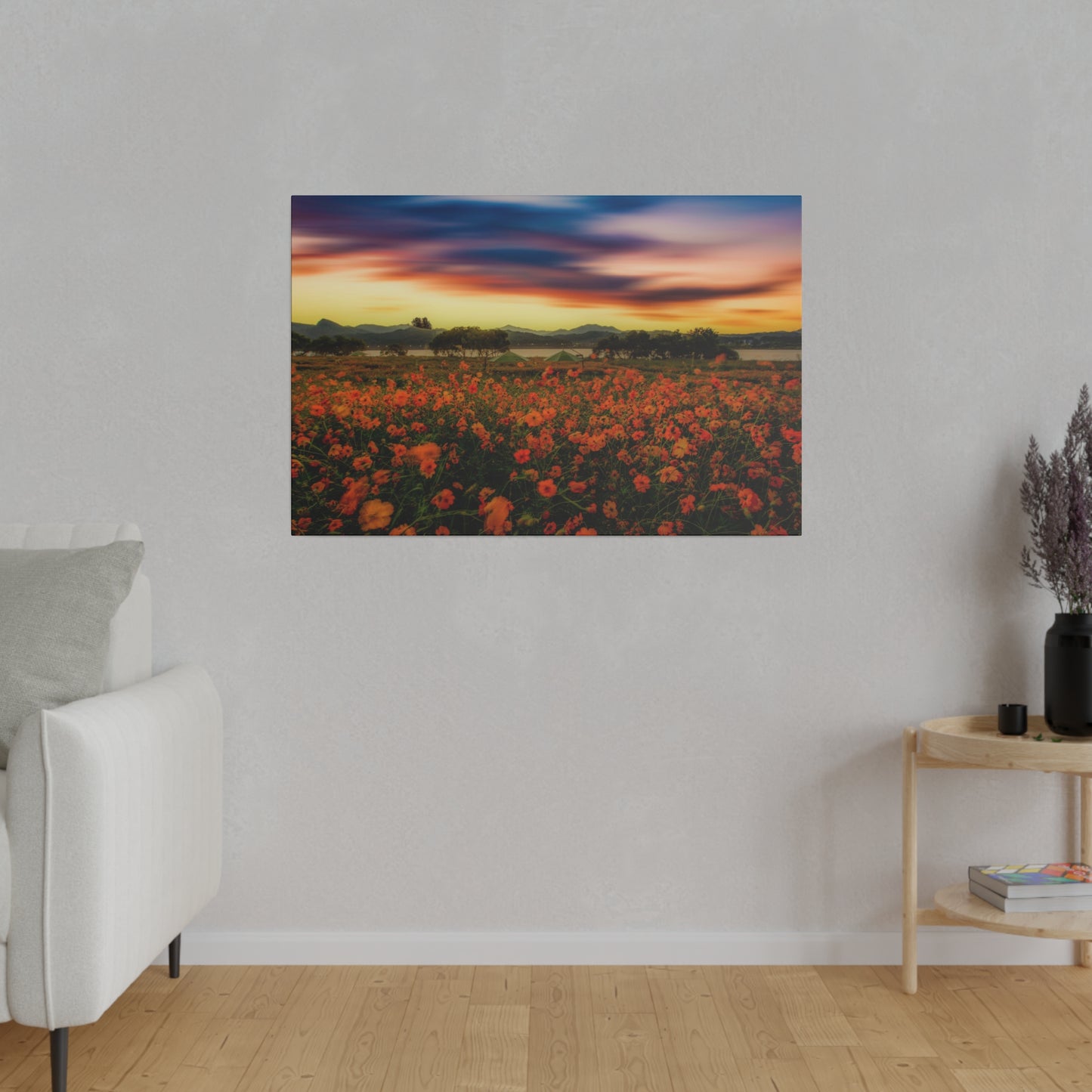 The horizon is alight with a spectacular sunset over a field of flowers, creating a breathtaking view of natural beauty.