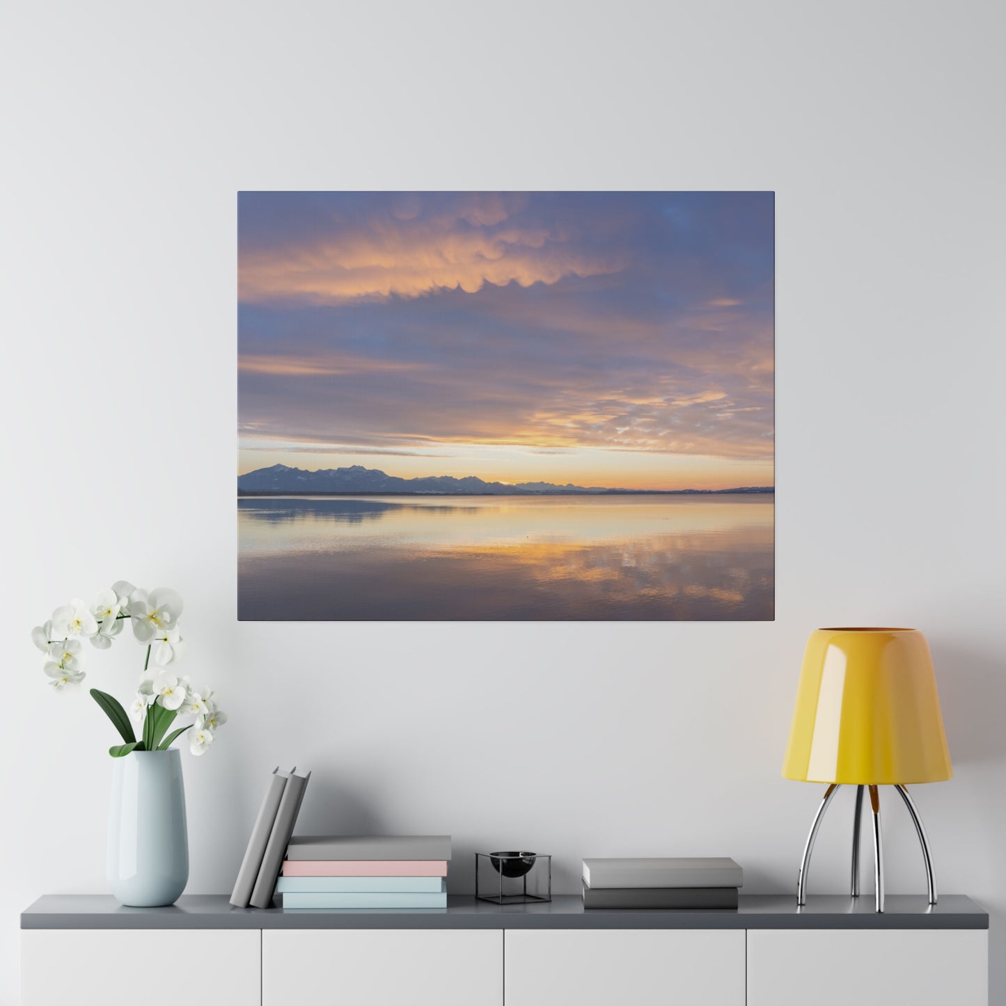 A peaceful sunset reflection on a still lake, with the sky painted in gentle hues of orange and purple. The serene scene captures the tranquility of dusk.