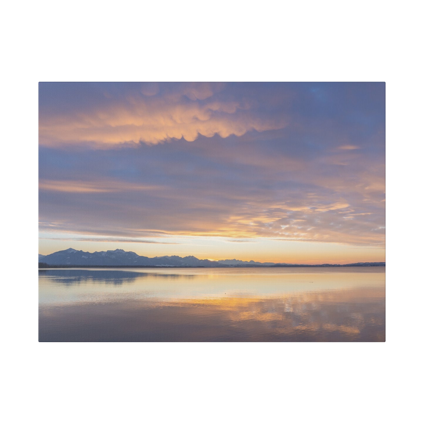 A peaceful sunset scene over a calm lake, with the sky painted in shades of orange and purple. The tranquil water perfectly reflects the serene and colorful sky.