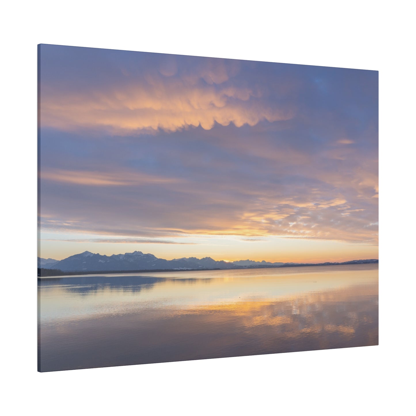 A sunset sky over a calm lake, with soft clouds illuminated in shades of orange and purple. The peaceful scene is beautifully reflected on the still water.