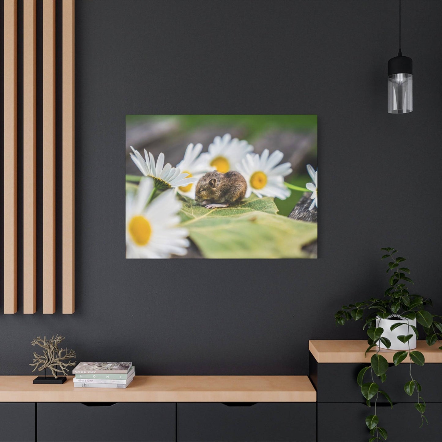 a rodent sitting on top of a flower on a table