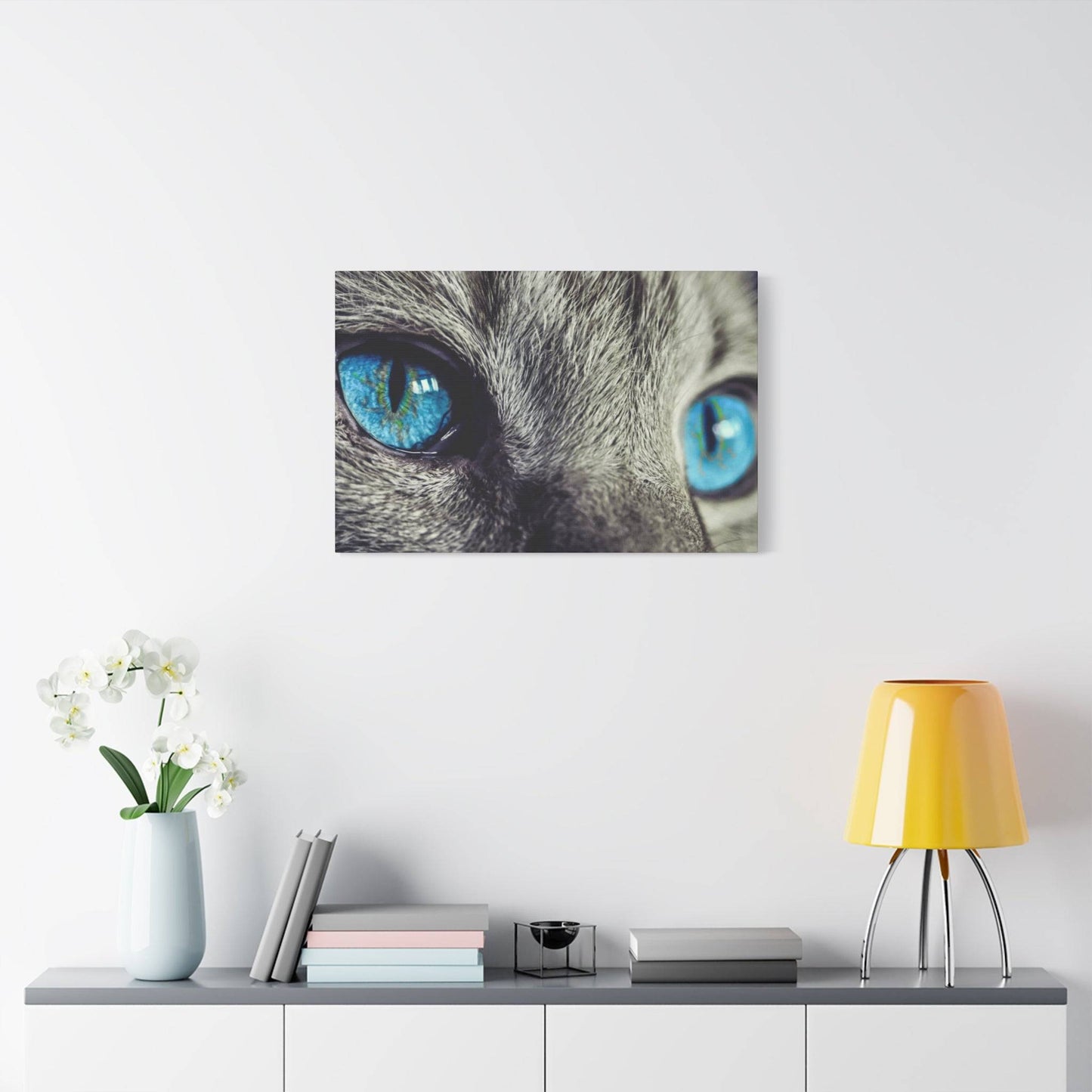 a cat's blue eyes are shown on a white wall