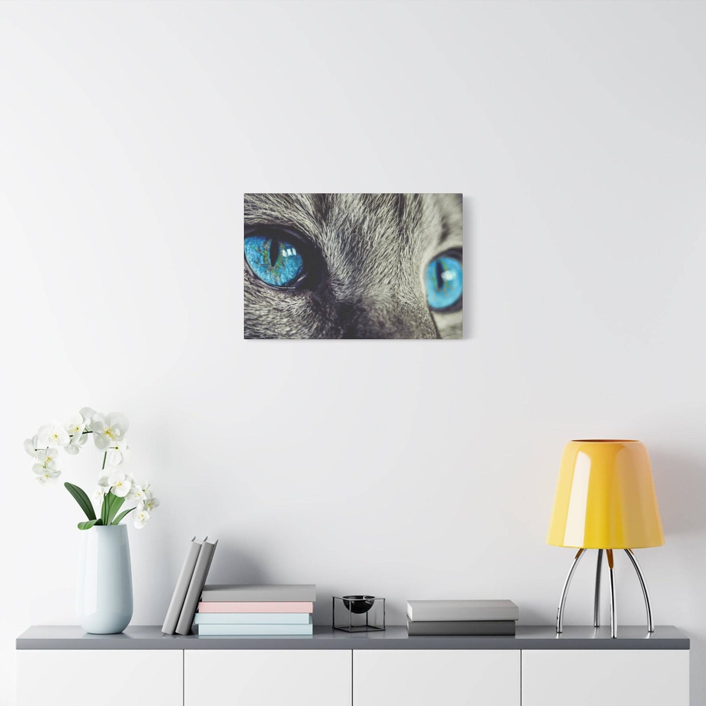 a picture of a cat's blue eyes on a white wall