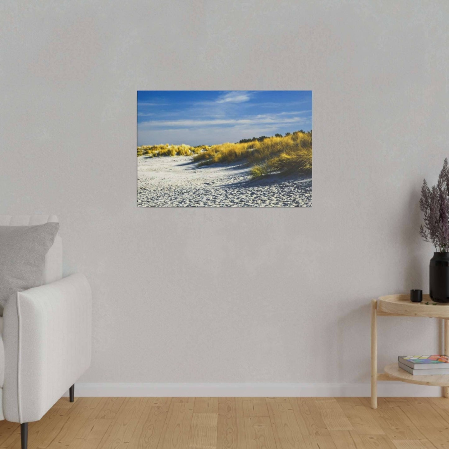 Golden dune grasses under a clear, bright blue sky, swaying gently on a serene beach.