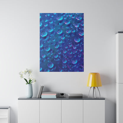 Blue poster of bubbles on a white wall above a white cabinet with books, a vase, and a yellow lamp.