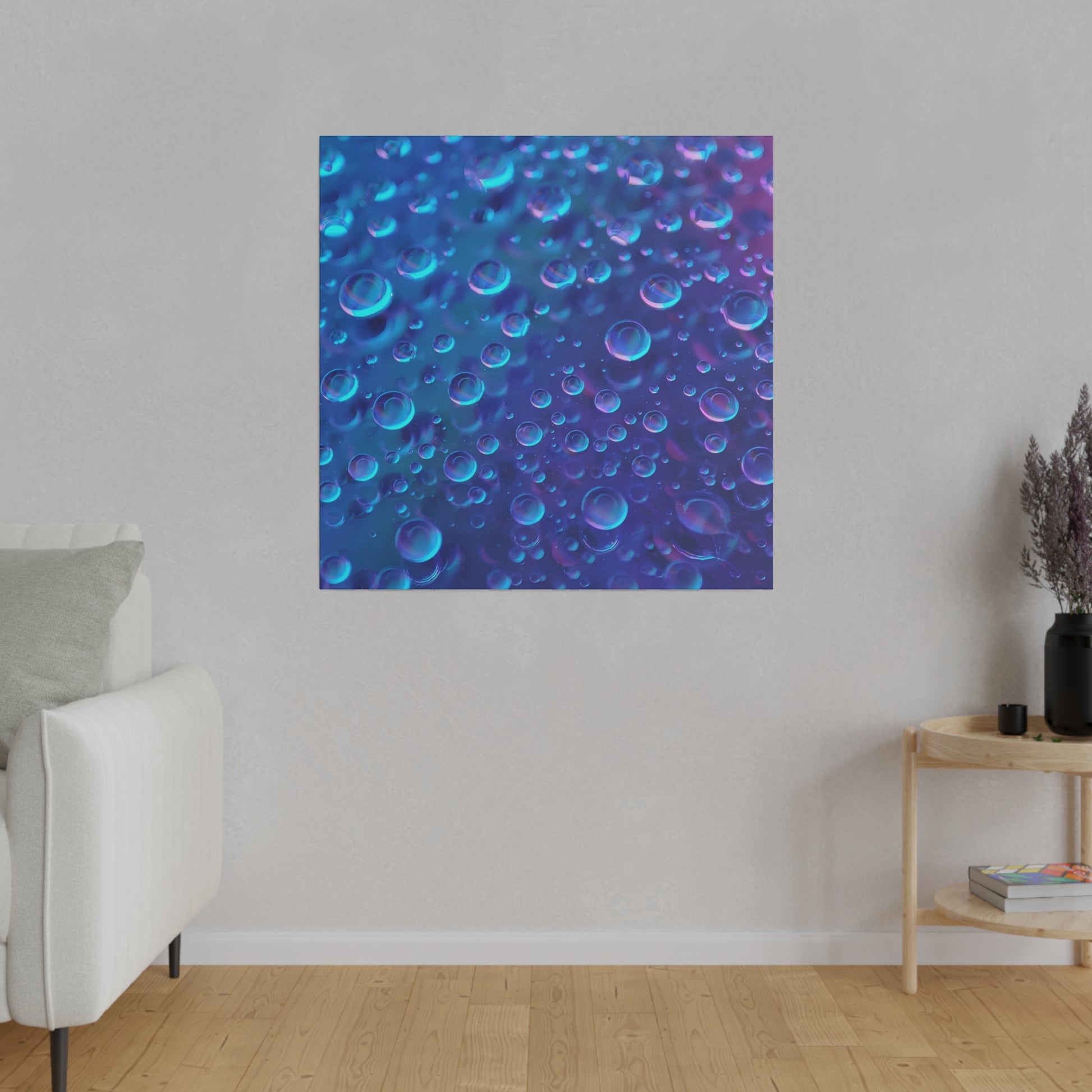 Blue abstract square canvas depicting numerous translucent bubbles in varying blue and purple tones, hanging on a light gray wall.