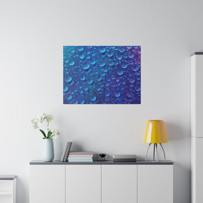 Blue abstract canvas print of bubbles hangs above a white cabinet with a yellow lamp and vase of white orchids.