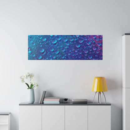 Rectangular blue abstract wall art with bubble patterns hangs above a white cabinet topped with books, a yellow lamp, and a vase of white