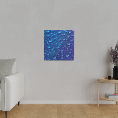 Square blue abstract print with numerous bubbles on a blue gradient, hung on a light gray wall in a modern living room.