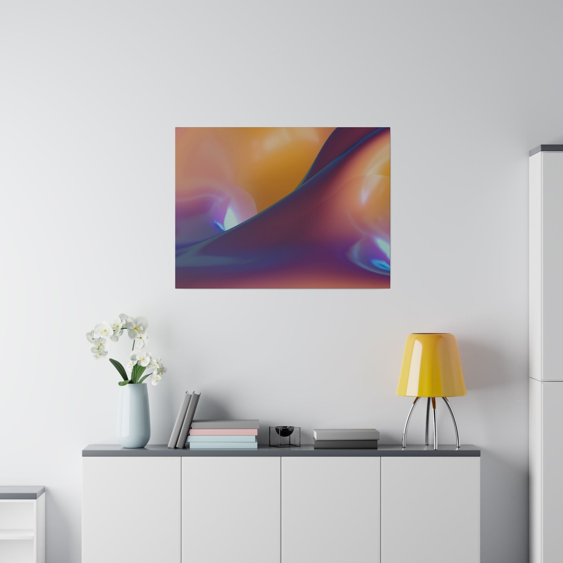 Abstract, multicolor artwork with orange, purple, and blue swirls hangs above a white cabinet with books, a light blue vase, and a yellow