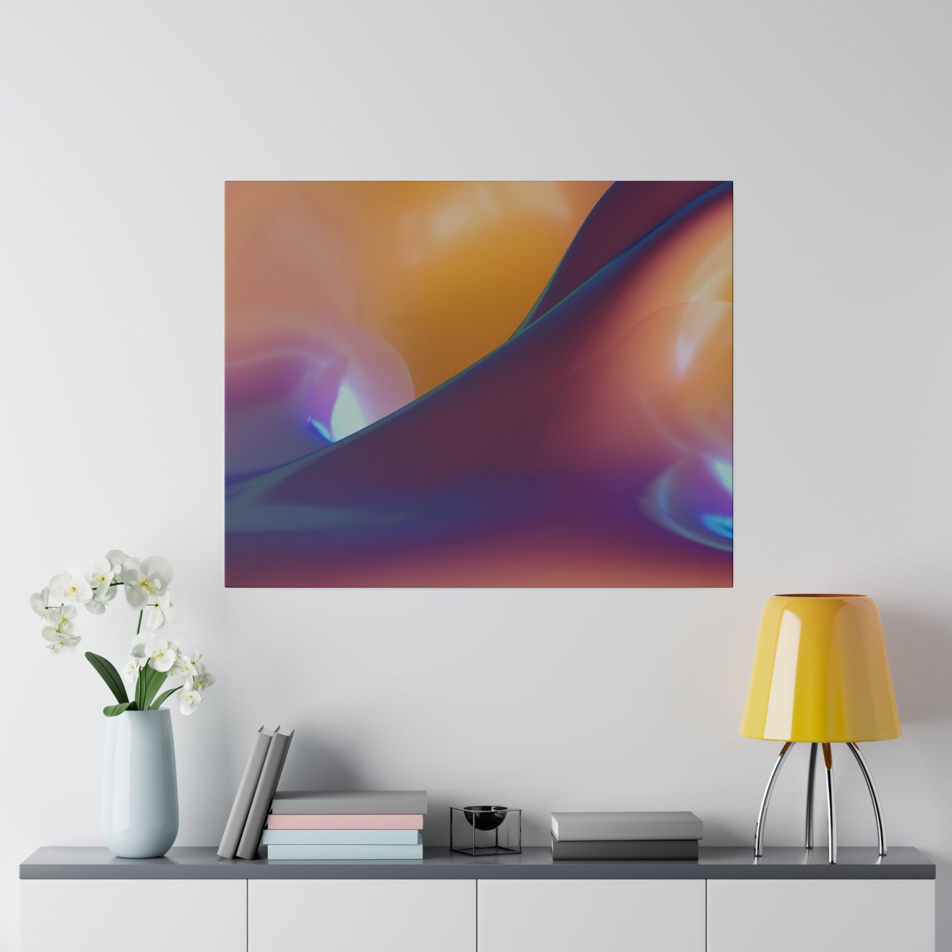Abstract square wall art with orange, purple, and blue gradients hung above a console table featuring a vase of white orchids, stacked