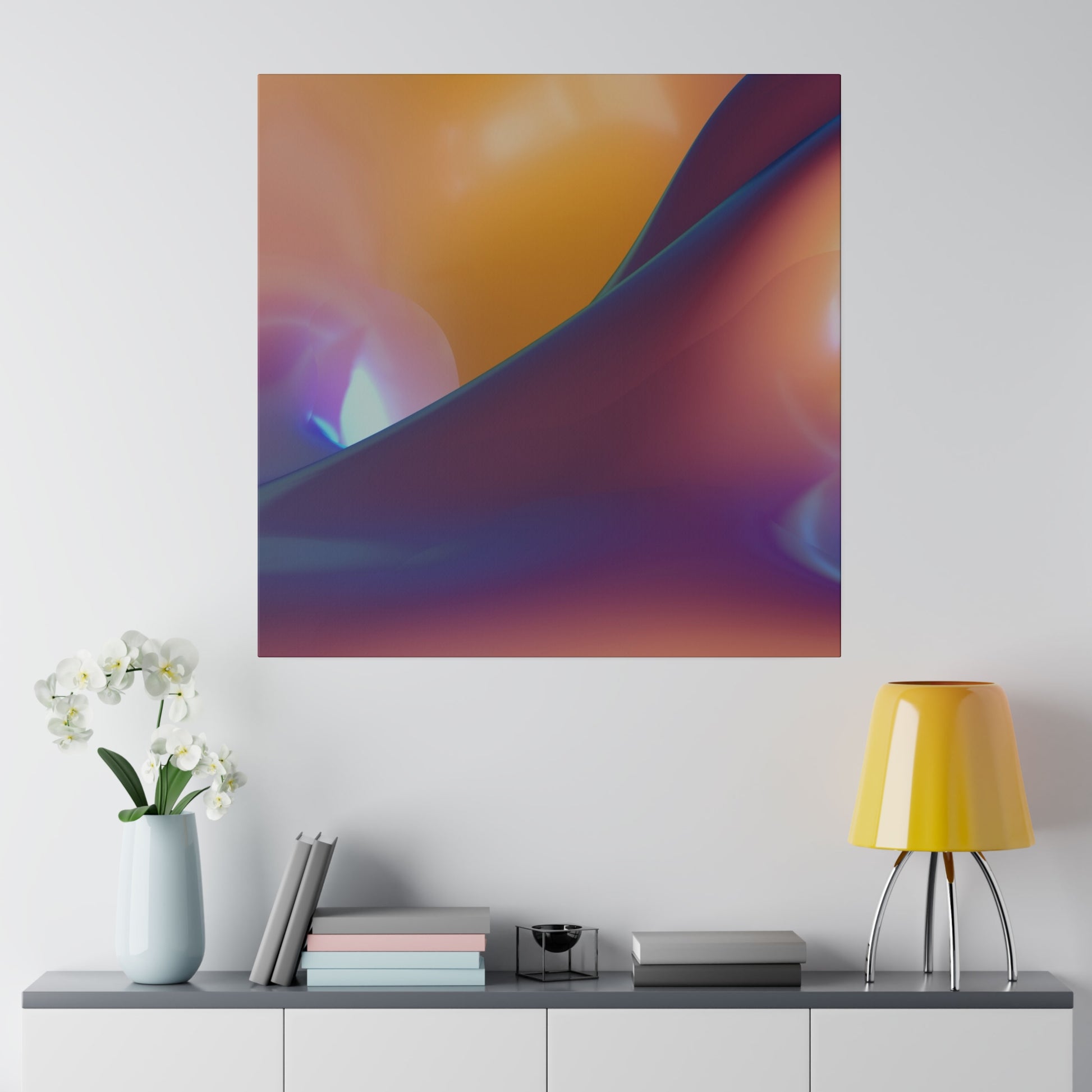 Abstract color gradient poster with orange, purple, and blue tones hanging on a white wall above a gray console with a pale blue vase of