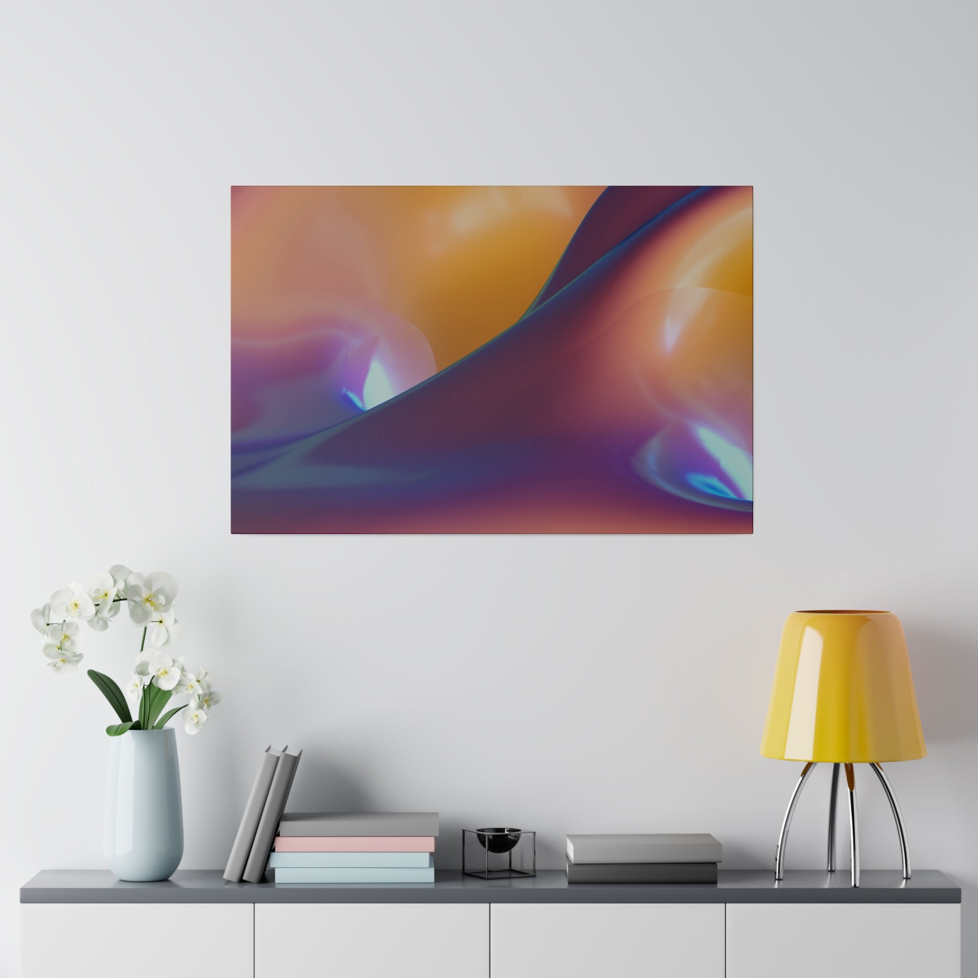 Abstract gradient artwork with orange, purple, and blue swirls hanging above a console table with a yellow lamp and white orchids.