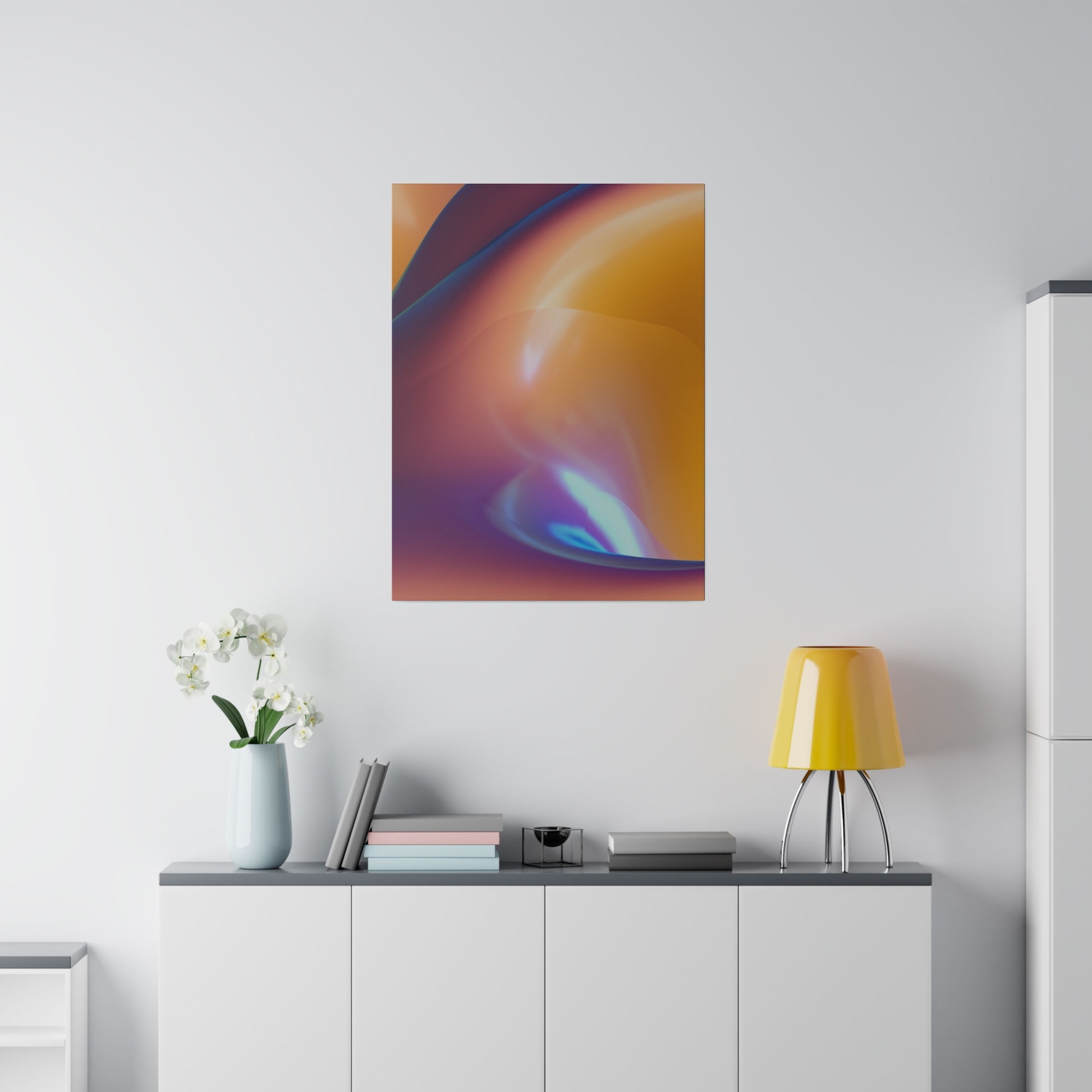 Abstract orange, purple, and blue poster on a white wall above a gray-topped cabinet, with a yellow lamp and white orchid vase.