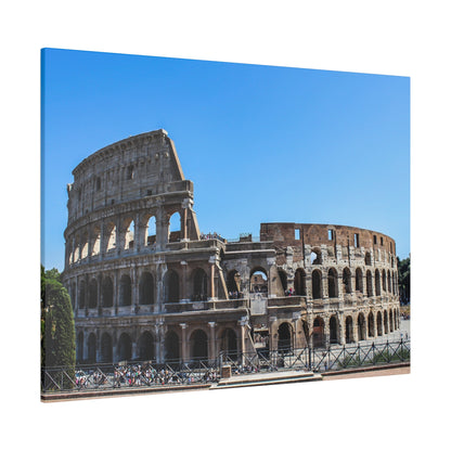 The Colosseum in Rome, a large ancient stone amphitheater with multiple arches under a clear blue sky.
