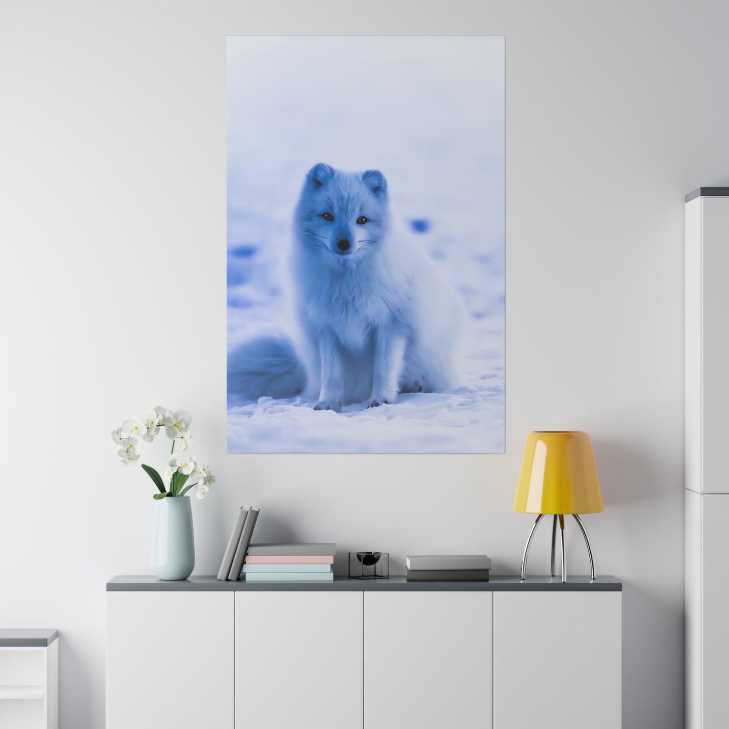 An Arctic fox, perfectly camouflaged in the snow with its white fur, sitting quietly and blending into the snowy background.