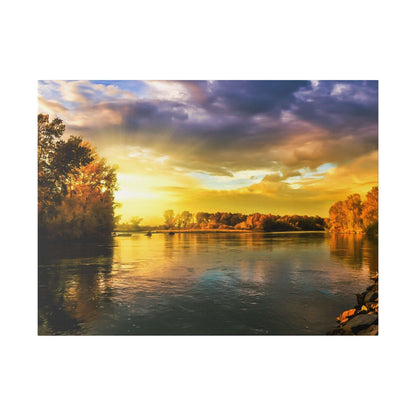 River at sunset with golden light reflecting off calm water, tree-lined banks on both sides.