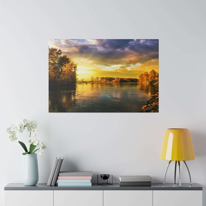 A framed landscape photo of a river at sunset, with orange and yellow sky and trees along the shoreline.
