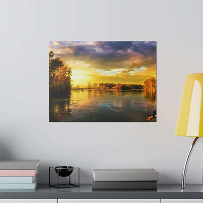 Canvas wall art of a sunset over a calm river with tree-lined banks and an orange-yellow sky reflection.