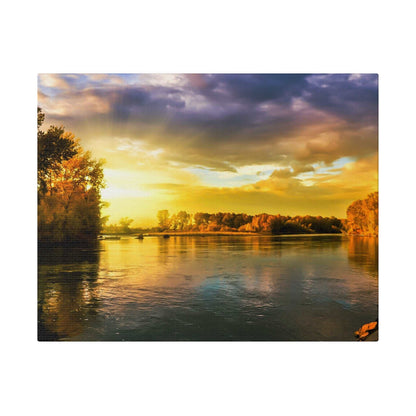River scene at sunset with a golden sky, calm water, and autumn-colored trees along the banks.