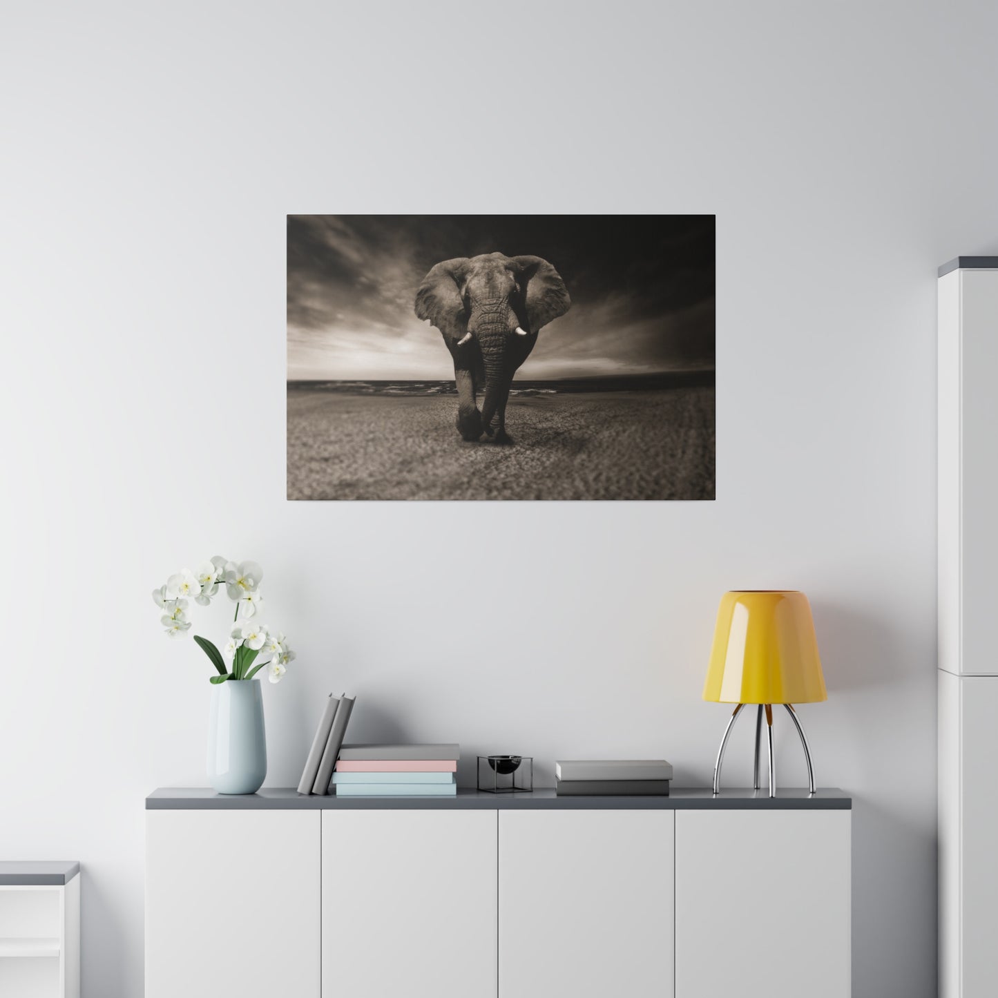 A detailed portrait of an elephant on the beach, with its eyes and features highlighted against the dramatic seascape.