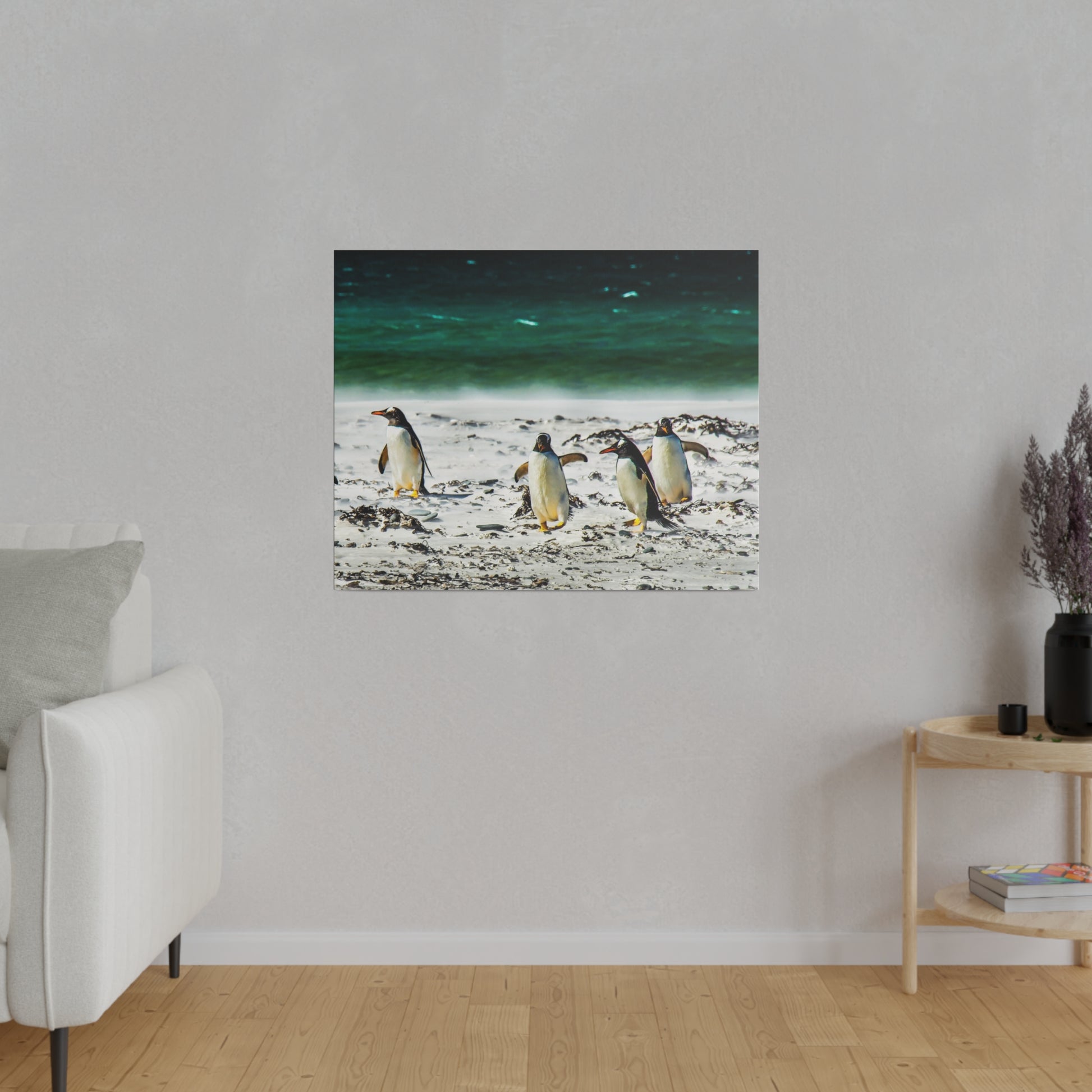 Penguins walking along the beachside, with the ocean waves in the background. The serene coastal scene captures the penguins in their natural habitat.