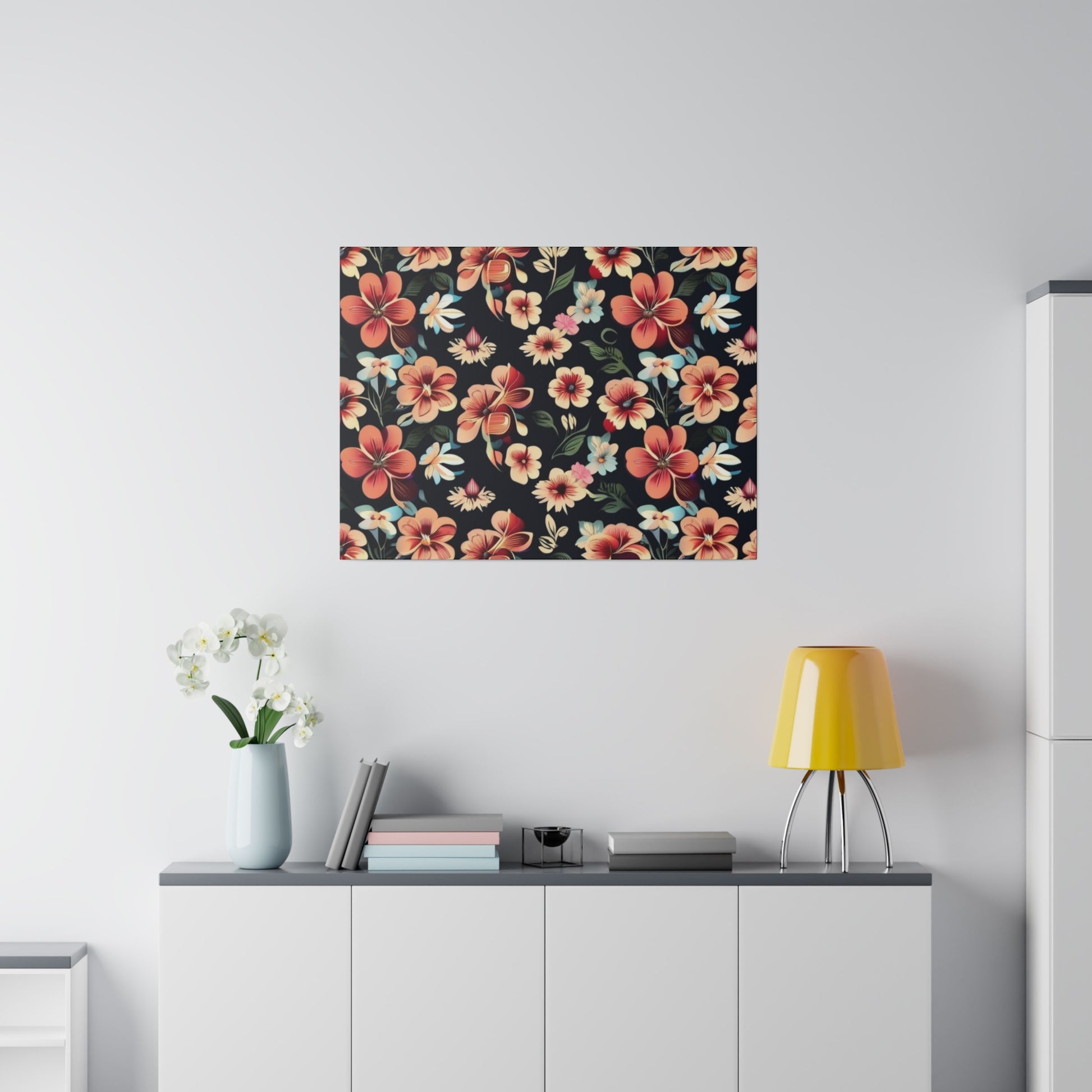 Rectangular wall art featuring red, pink, and cream flowers on a black background, mounted above a white cabinet.