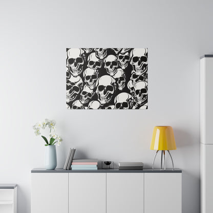 Framed black-and-white skull-pattern wall art above a white cabinet with a pale blue vase of white orchids, books, and a yellow table lamp.
