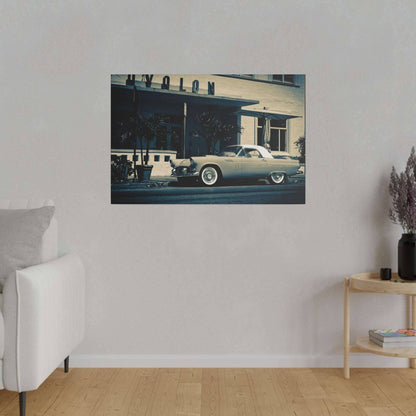 A beige living room wall with a framed vintage silver car artwork hung above a white sofa.