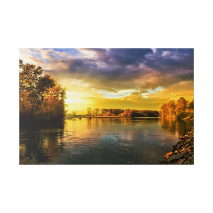 River scene at sunset with orange and yellow autumn trees along the banks and calm water reflecting the sky.