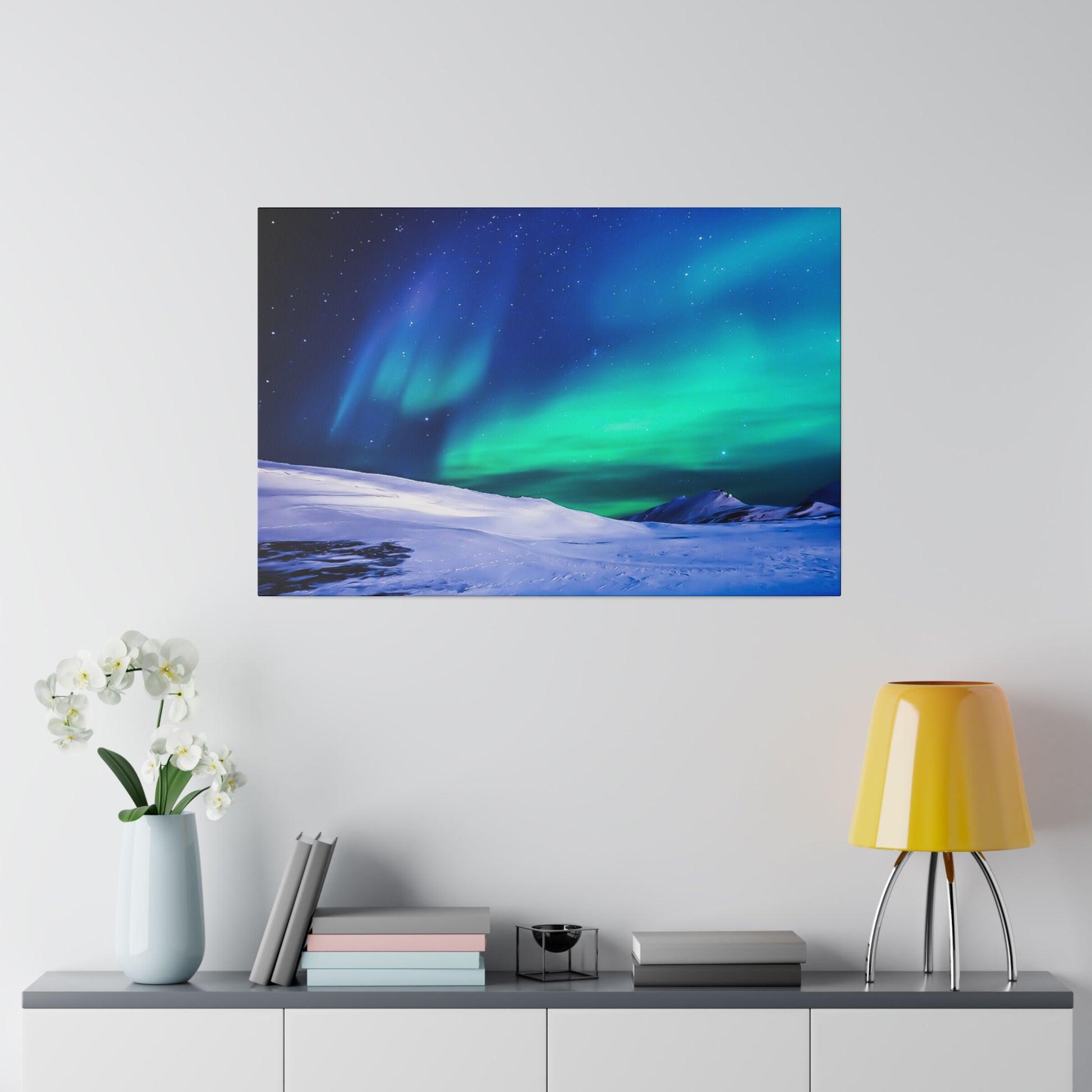 Rectangular wall art showing the aurora borealis in green and blue over a snow-covered landscape.