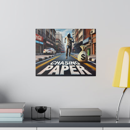 Colorful city street poster of a man in a hoodie running toward a large money bag, with "CHASING PAPER" painted on the road.