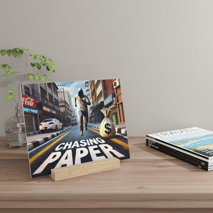 Poster on a wooden stand shows a man running down a city street with a money bag, bold "CHASING PAPER" text across the road.