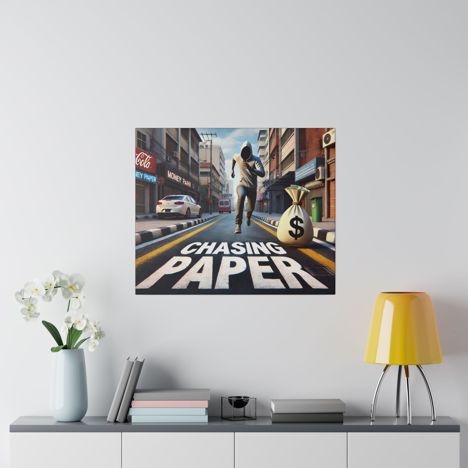 Canvas print of an urban street scene with a hooded runner and a money bag on a crosswalk, reading 'Chasing Paper'.