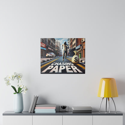 Square poster on a white wall shows a city street with a runner and a large money bag, and the words Chasing Paper.