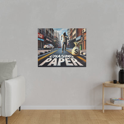 Square wall art showing a city street with a runner chasing a money bag and the words "Chasing Paper" on the road.