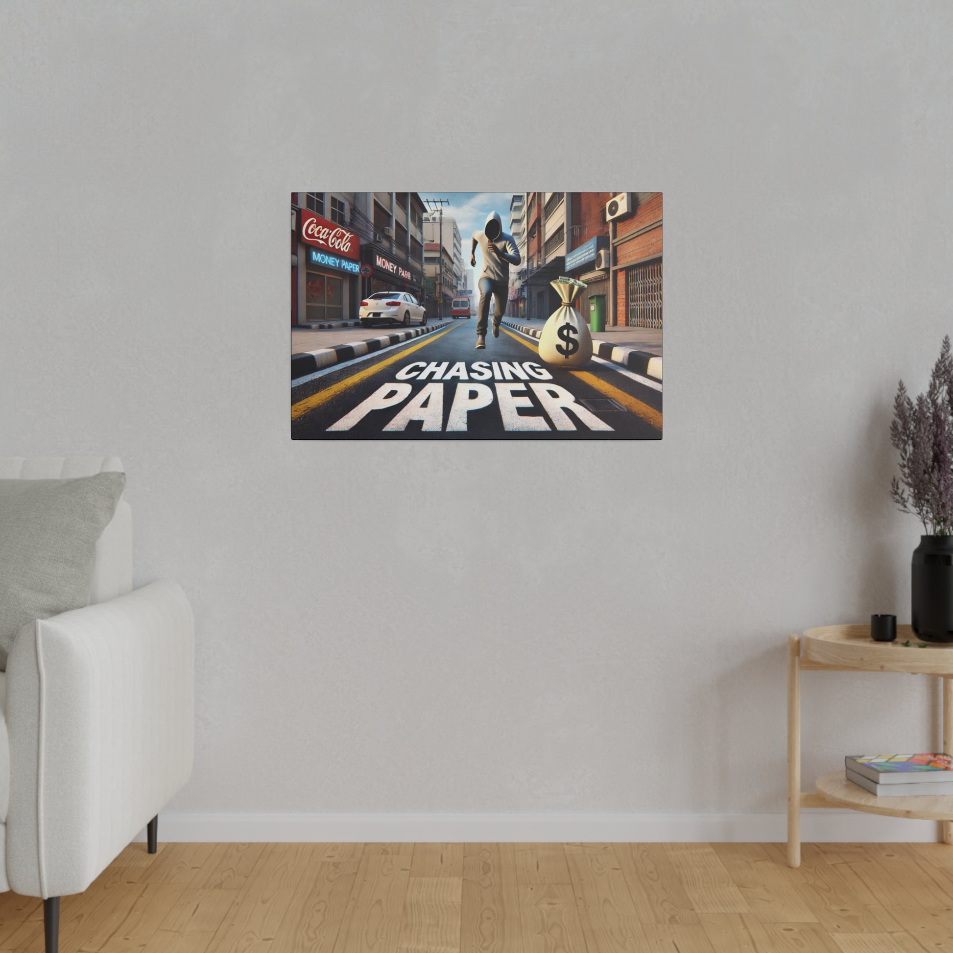 Poster on a gray wall depicting a city street with a runner and a large money bag, and the words “Chasing Paper” painted on the road.
