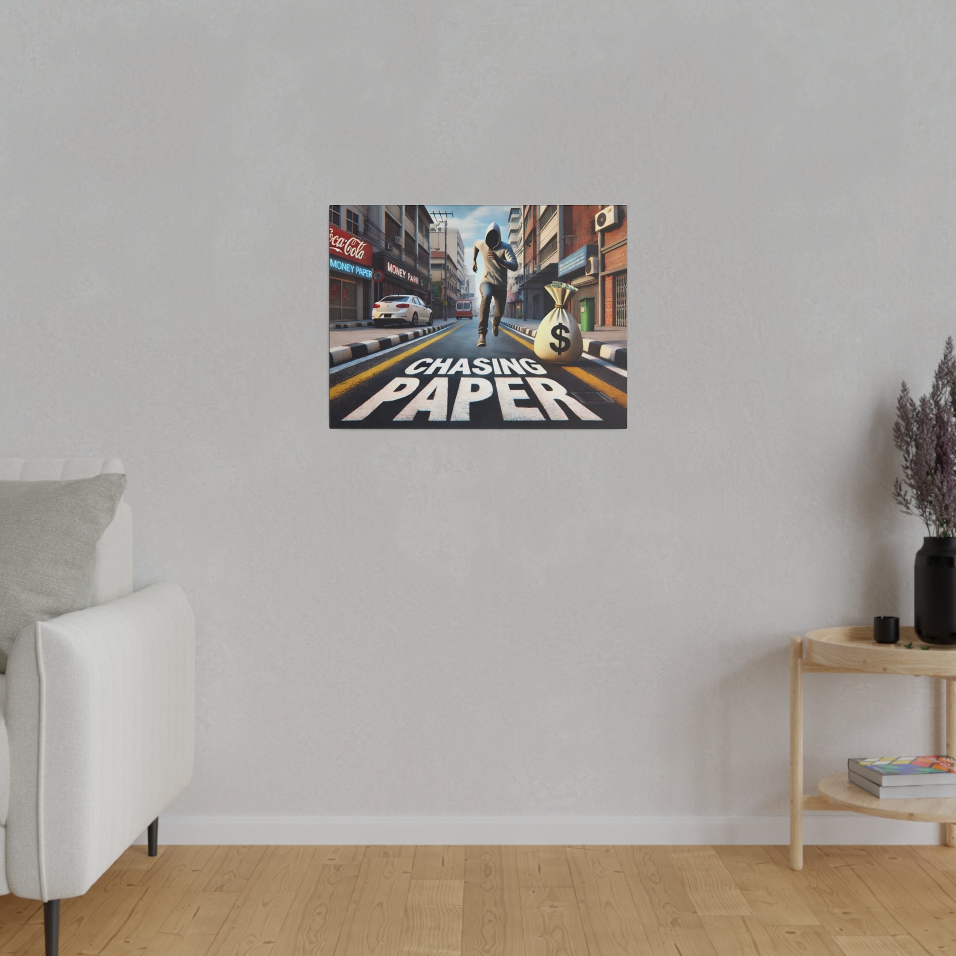 Colorful movie-style poster on a gray wall showing a man running down a city street with a money bag, text “Chasing Paper.”