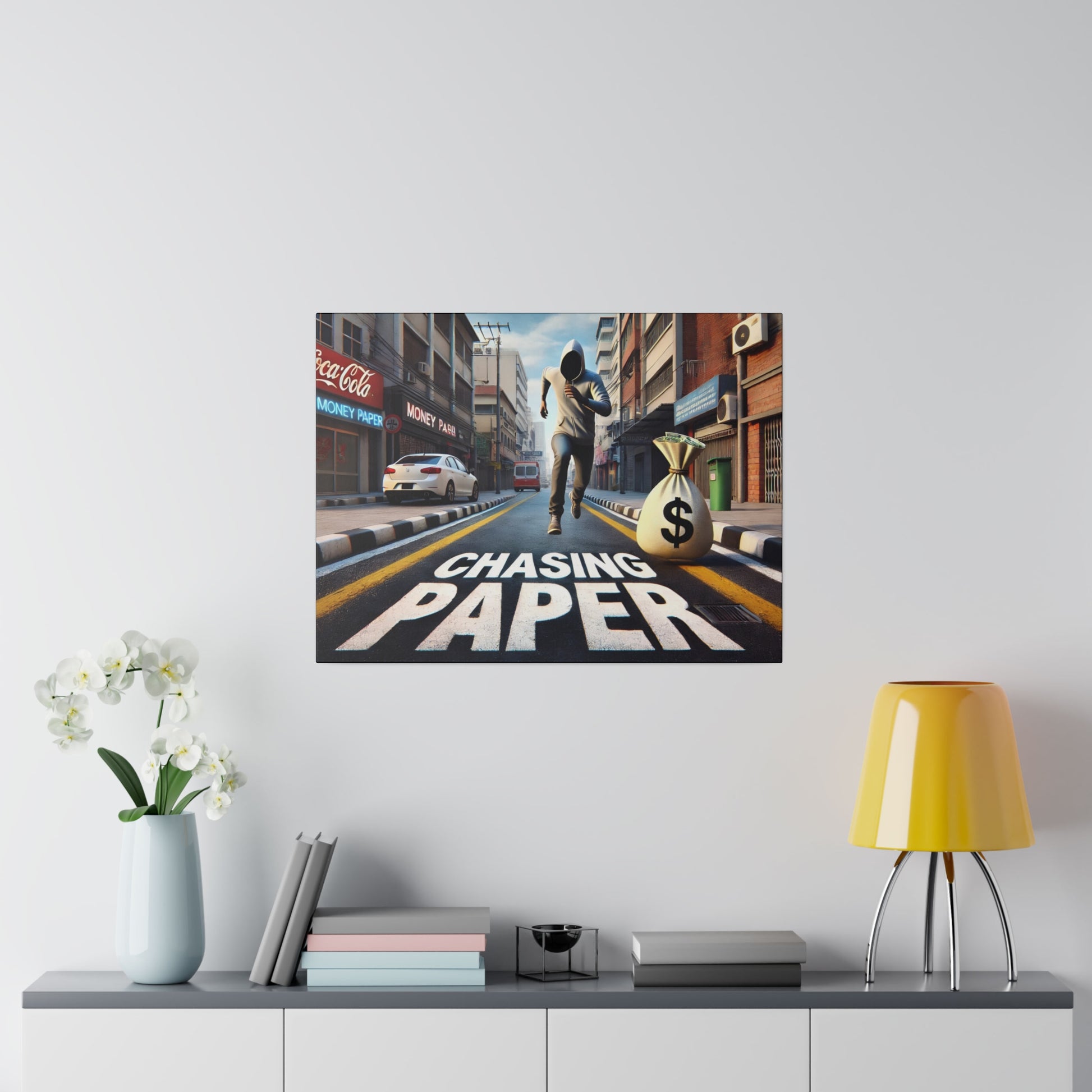 Poster on wall depicting a runner sprinting down a city street beside a large money bag with a bold "CHASING PAPER" title.