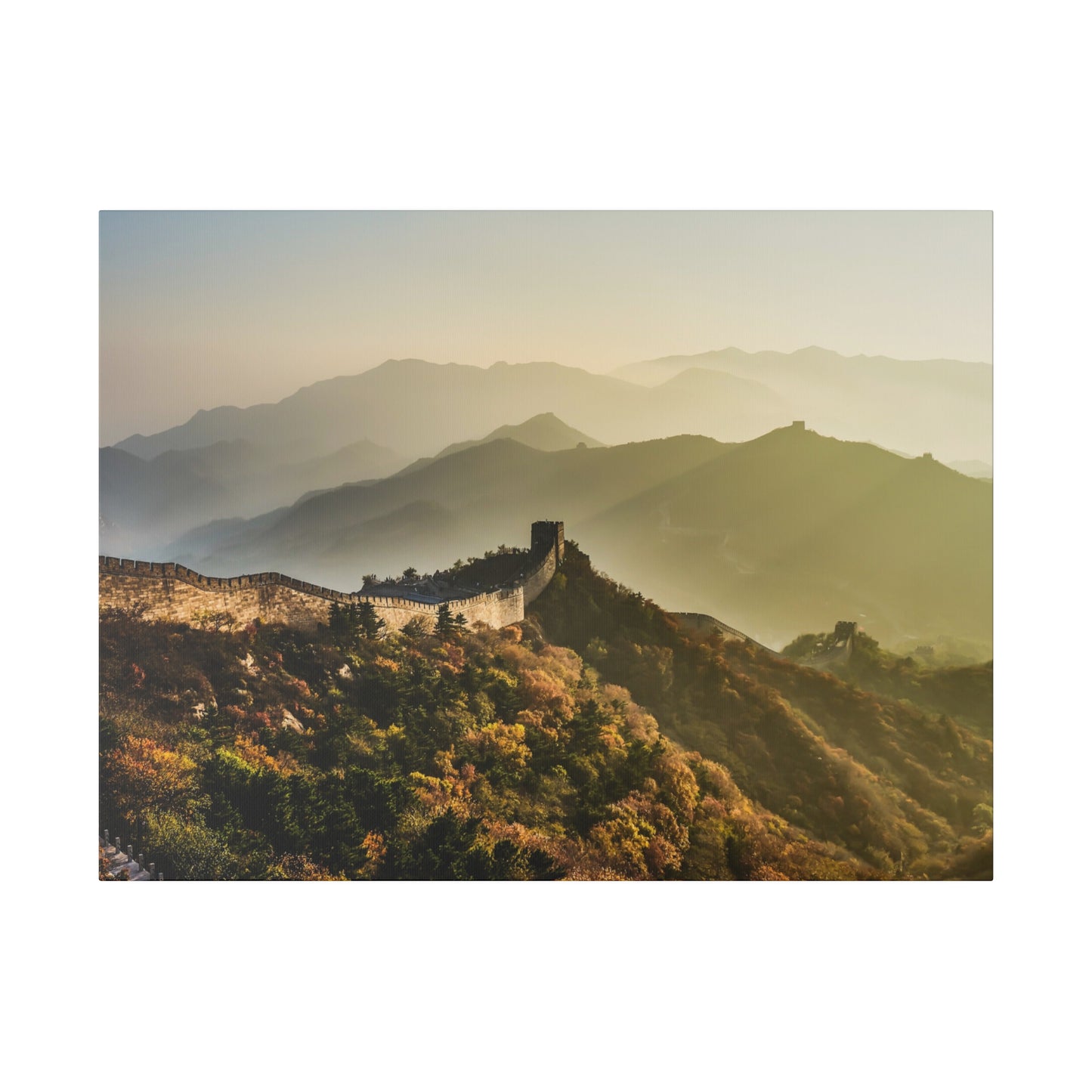 A panoramic view of the Great Wall of China, winding through a historical mountain range under a clear sky.