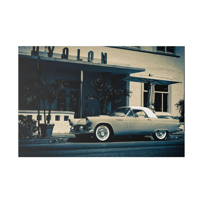 A light blue vintage convertible parked on a street in front of a midcentury storefront with palm trees.