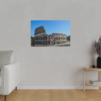 Color photograph of the Colosseum in Rome, showing its stone arches under a clear blue sky.