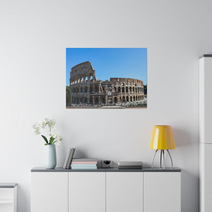 Color photograph of the Colosseum in Rome with a blue sky, hung on a white wall above a modern sideboard.
