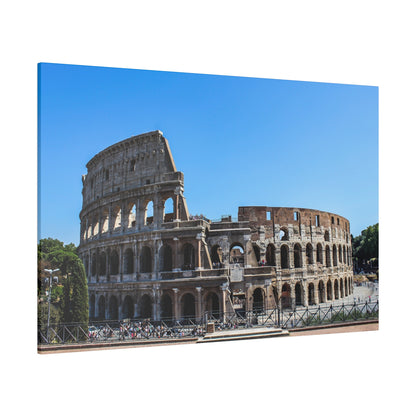 Exterior view of the ancient Colosseum in Rome, a stone arena with multiple arches under a clear blue sky.