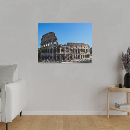 Photograph of the Colosseum in Rome, showing stone arches against a blue sky, mounted on a light gray wall in a living room.