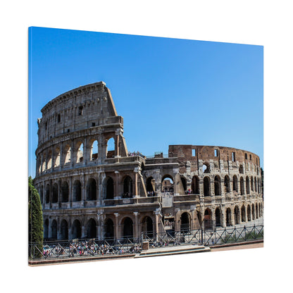 The Colosseum in Rome, a massive ancient stone amphitheater with many arches, set against a bright blue sky.